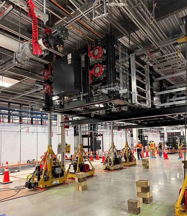 Precision indoor heavy lifting and equipment positioning using hydraulic gantry towers in Manassas, Virginia.