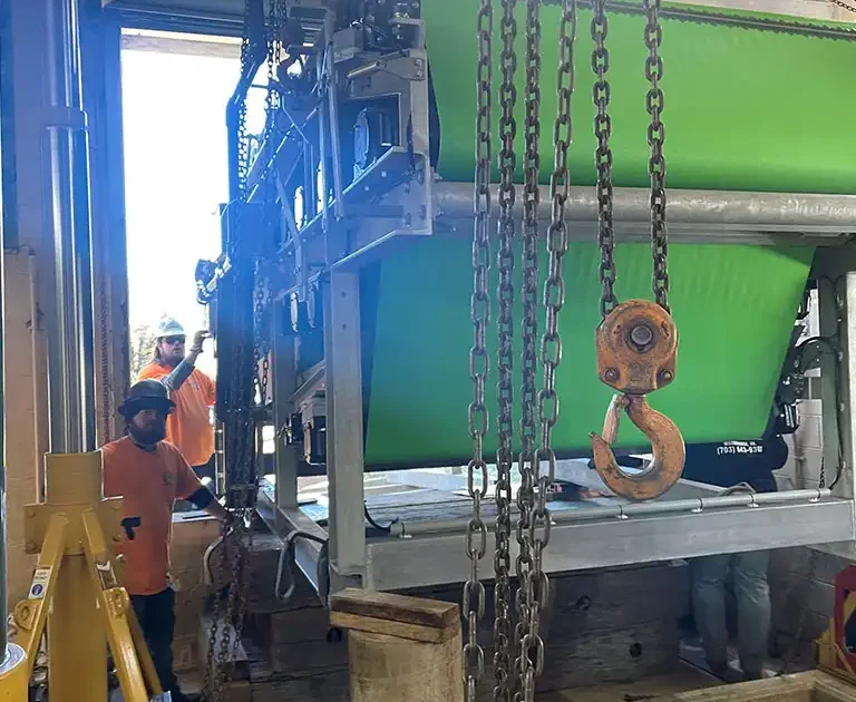 CMR Crane and Rigging team using hydraulic gantry jacks and chain falls to install machinery in Dahlgren, Virginia.
