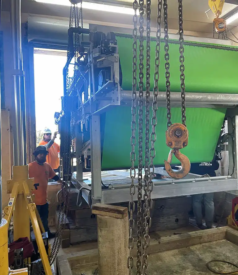 CMR Crane and Rigging team using hydraulic gantry jacks and chain falls to install machinery in Dahlgren, Virginia.